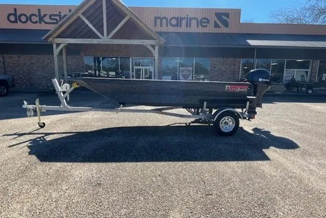 Slide: The Image of 2026 Reaper Boats 553-1689 model on trailer outside marine store. - 9