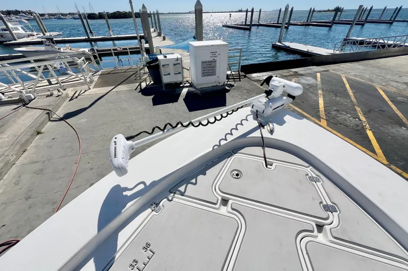 Slide: The Image of 2016 Sportsman Masters 247 Bay Boat docked, showcasing sleek design and steering console. - 14