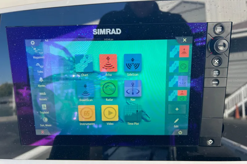 Slide: The Image of 2016 Sportsman Masters 247 Bay Boat docked with American flag in background. - 3