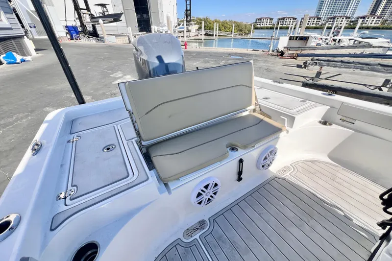 Slide: The Image of 2016 Sportsman Masters 247 Bay Boat docked with Yamaha engine, sunny marina backdrop. - 4