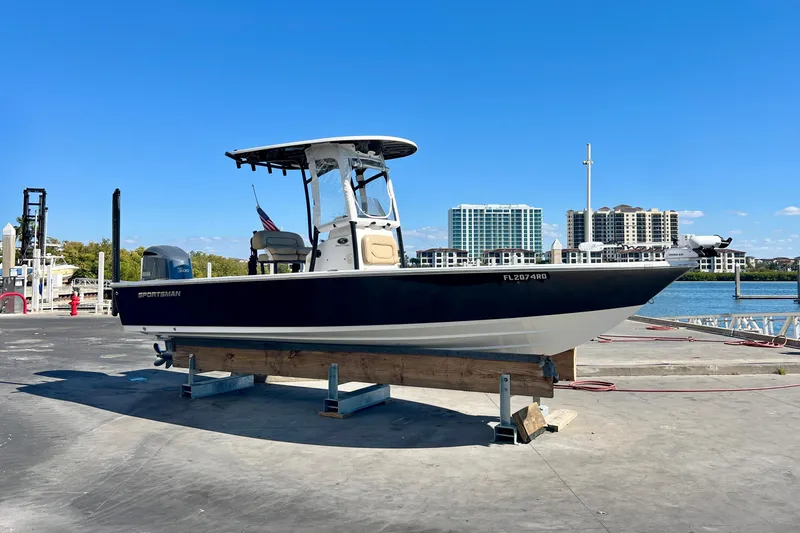 Slide: The Image of 2016 Sportsman Masters 247 Bay Boat at dock with American flag in background. - 5