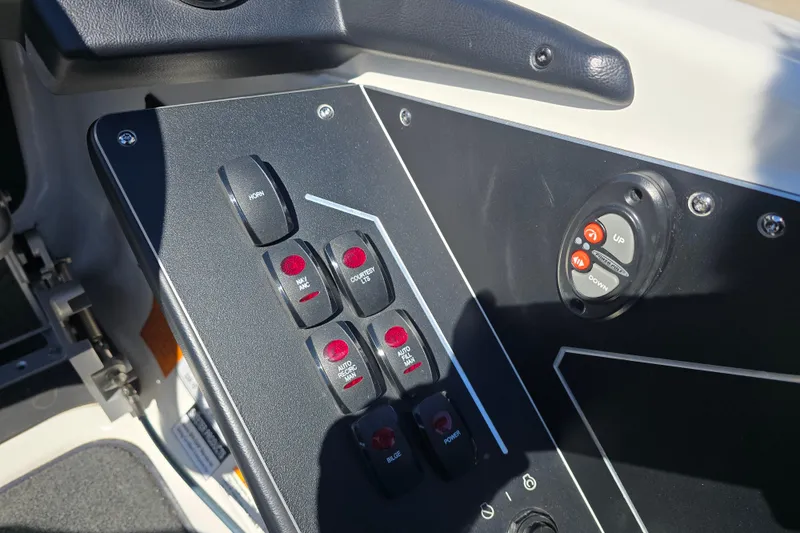 Slide: The Image of Control panel of 2023 Skeeter ZXR19 boat with switches and buttons. - 13