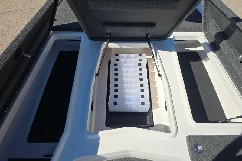 Slide: The Image of 2023 Skeeter ZXR19 boat storage compartment with organized tackle boxes. - 15
