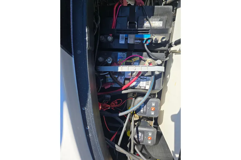 Slide: The Image of 2023 Skeeter ZXR19 boat battery compartment with wiring and connections. - 19