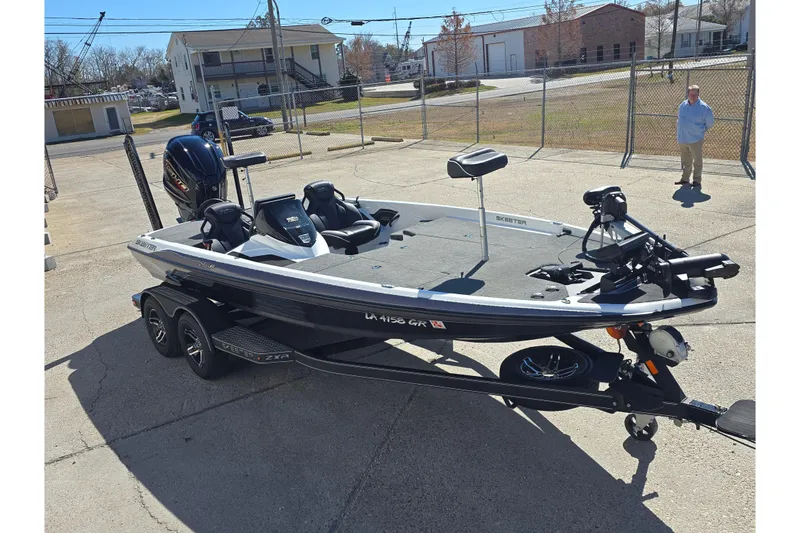 Slide: The Image of 2023 Skeeter ZXR19 boat on trailer in outdoor setting. - 2