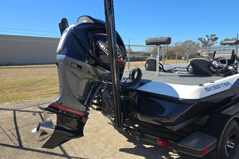 Slide: The Image of 2023 Skeeter ZXR19 boat with Yamaha outboard motor, parked outdoors. - 21