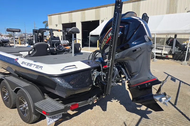 Slide: The Image of 2023 Skeeter ZXR19 boat with powerful outboard motor, parked on a trailer. - 22