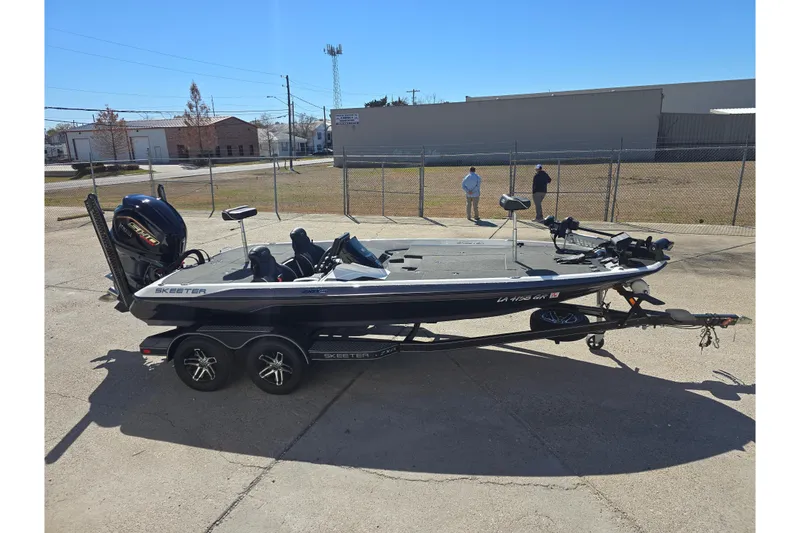 Slide: The Image of 2023 Skeeter ZXR19 fishing boat on trailer in outdoor setting. - 3
