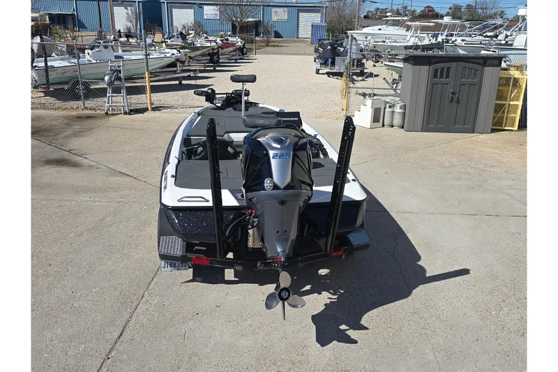 Slide: The Image of 2023 Skeeter ZXR19 boat with powerful outboard motor in a marina setting. - 5