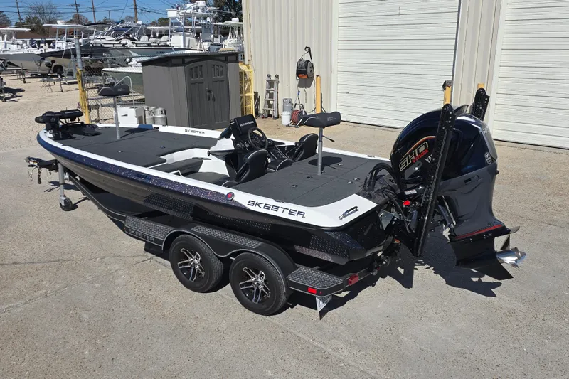 Slide: The Image of 2023 Skeeter ZXR19 boat with dual-axle trailer, parked outdoors. - 6