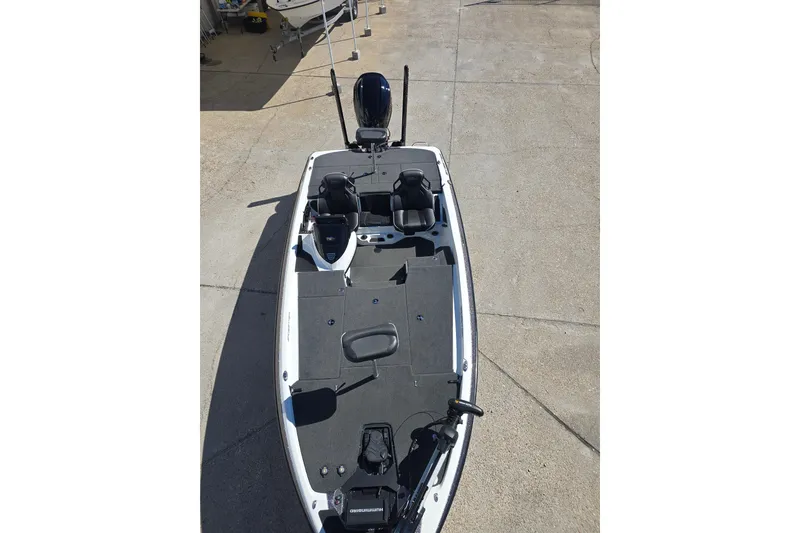 Slide: The Image of 2023 Skeeter ZXR19 fishing boat with dual seats and trolling motor on concrete surface. - 9