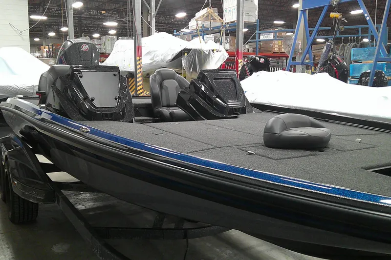 Slide: The Image of 2025 Nitro Z21 XL boat in a warehouse, showcasing sleek design and spacious deck. - 2