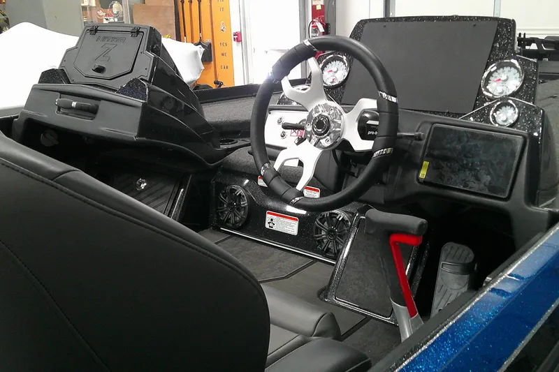 Slide: The Image of 2025 Nitro Z21 XL boat cockpit with steering wheel and dashboard controls. - 3