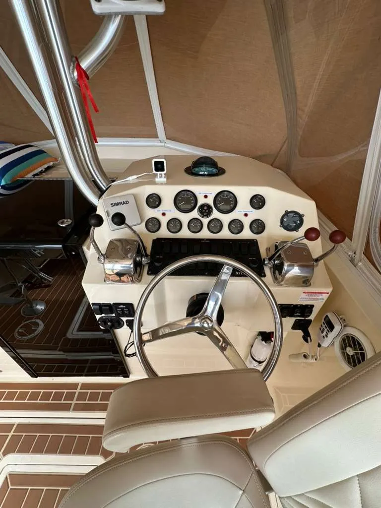 Slide: The Image of 1988 Atlantic 34 Express cockpit with steering wheel and instruments. - 23