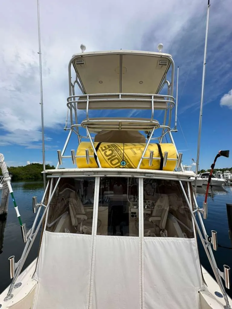 Slide: The Image of 1988 Atlantic 34 Express boat with yellow inflatable on top deck. - 25