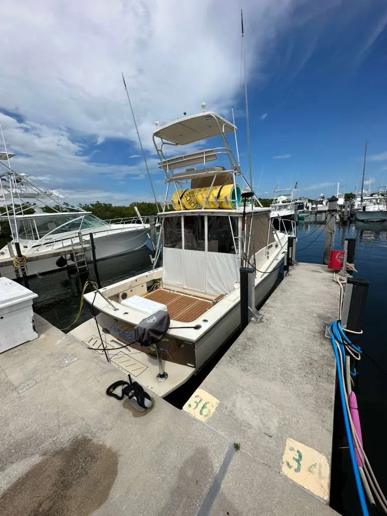 Slide: The Image of 1988 Atlantic 34 Express boat docked at marina. - 30