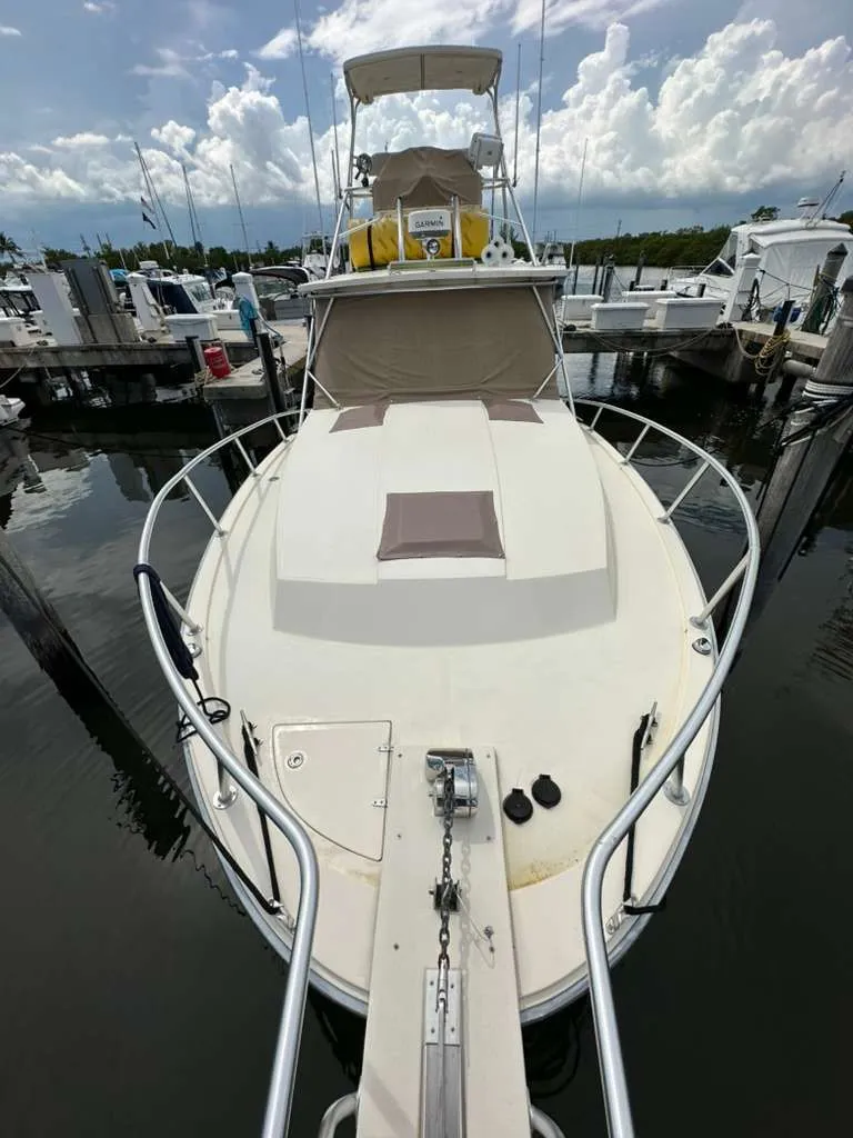 Slide: The Image of 1988 Atlantic 34 Express boat docked, front view. - 4