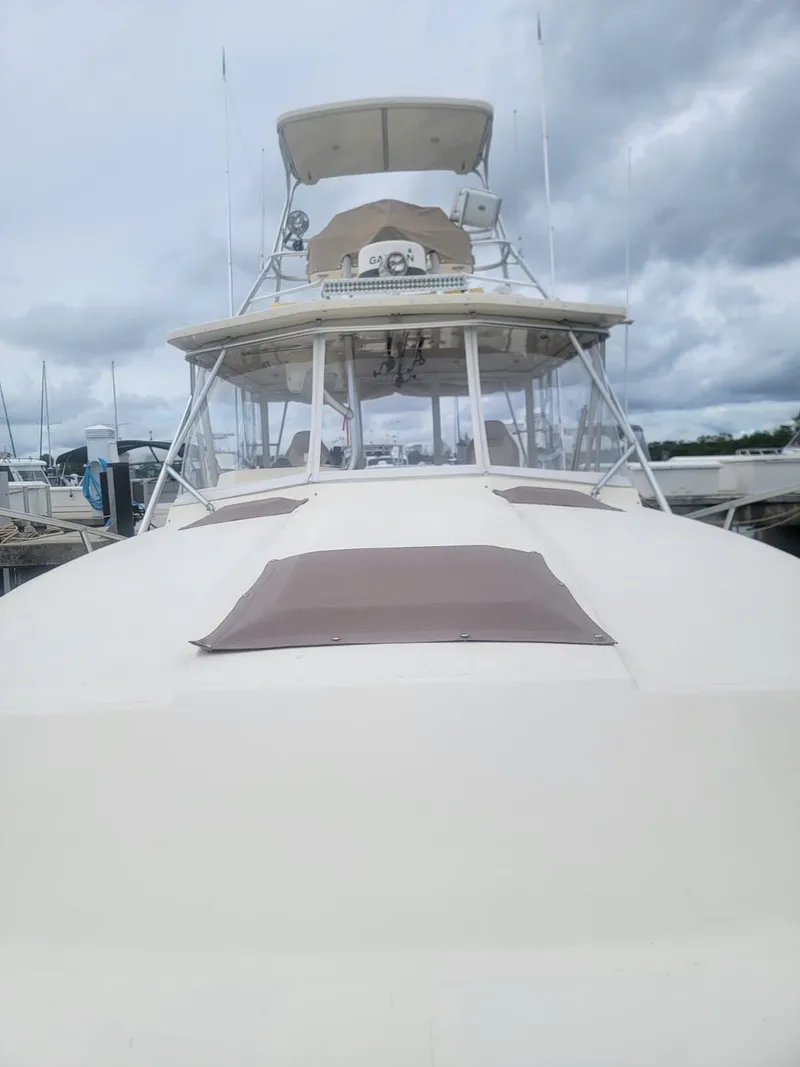 Slide: The Image of 1988 Atlantic 34 Express boat docked under cloudy skies. - 6