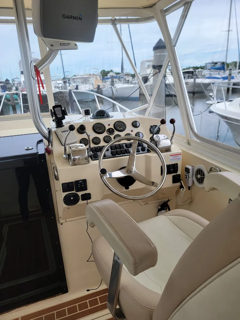 Slide: The Image of Helm of a 1988 Atlantic 34 Express boat in the marina. - 7