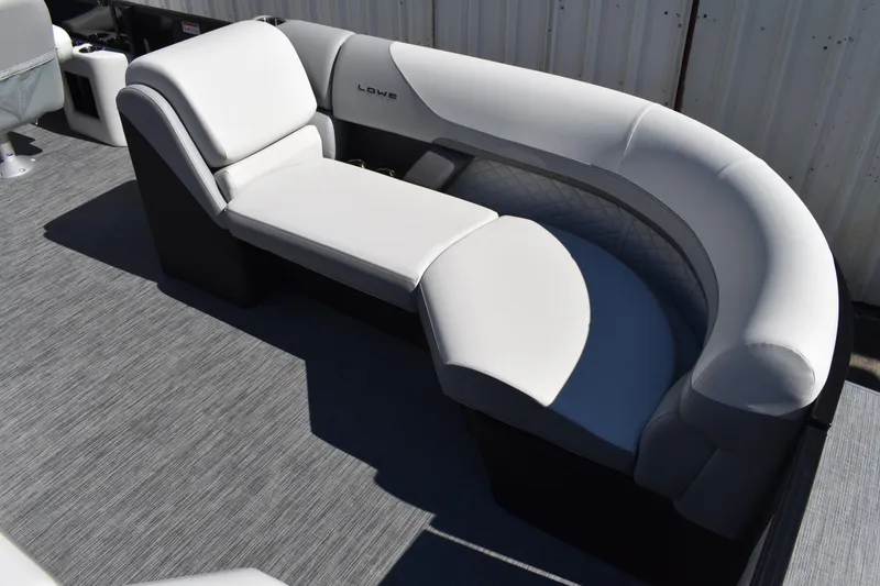 Slide: The Image of Luxurious seating on 2026 Lowe SS 230 WT pontoon boat, featuring sleek white upholstery. - 13