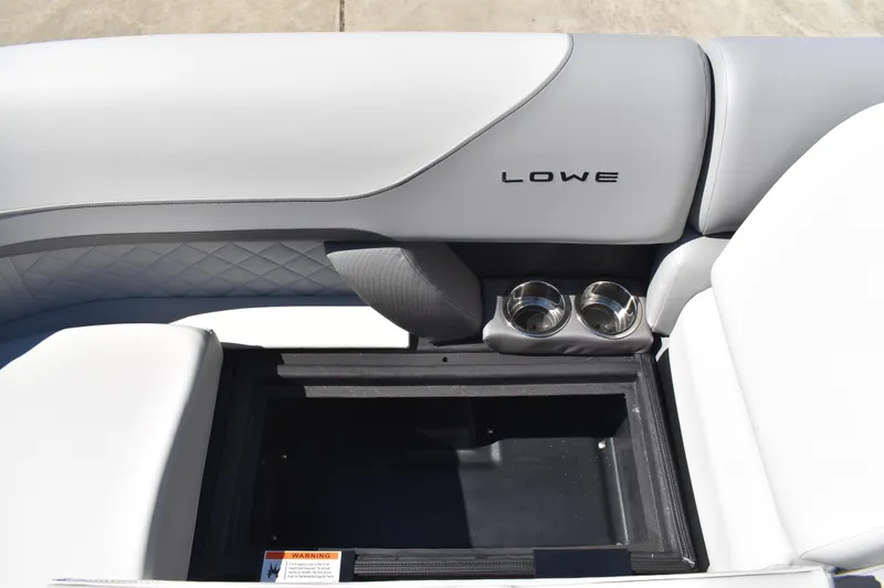 Slide: The Image of 2026 Lowe SS 230 WT boat interior with cup holders and storage compartment. - 17