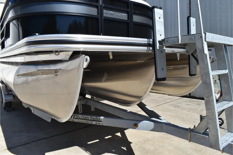 Slide: The Image of 2026 Lowe SS 230 WT Special pontoon boat on trailer, close-up view. - 2