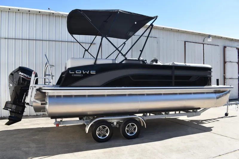 Slide: The Image of 2026 Lowe SS 230 WT pontoon boat with Mercury outboard engine on trailer. - 3