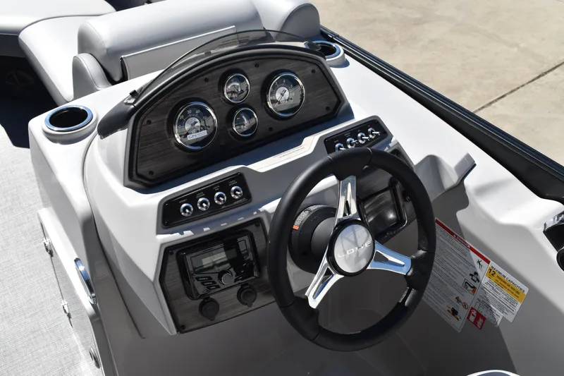 Slide: The Image of 2026 Lowe SS 230 WT boat dashboard with steering wheel and instrument panel. - 31