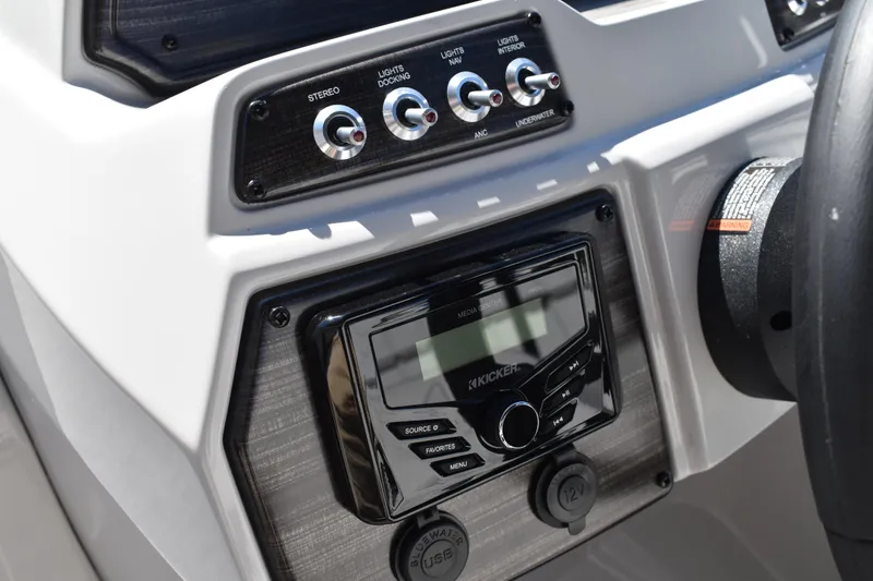Slide: The Image of Control panel of 2026 Lowe SS 230 WT boat with stereo and light switches. - 33