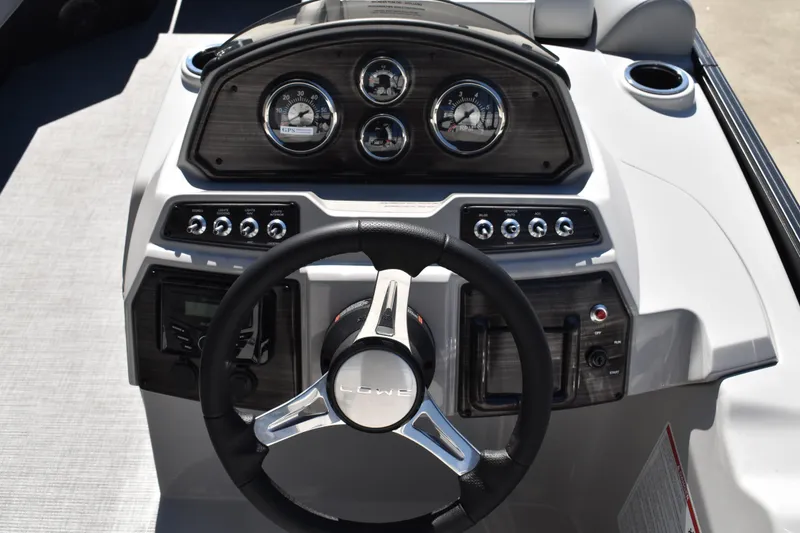 Slide: The Image of 2026 Lowe SS 230 WT boat dashboard with steering wheel and control panel. - 35