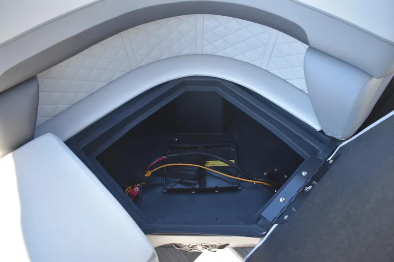 Slide: The Image of 2026 Lowe SS 230 WT boat storage compartment with quilted upholstery and wiring. - 41