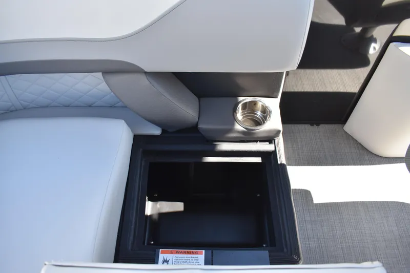 Slide: The Image of 2026 Lowe SS 230 WT boat interior with storage compartment and cup holder. - 43
