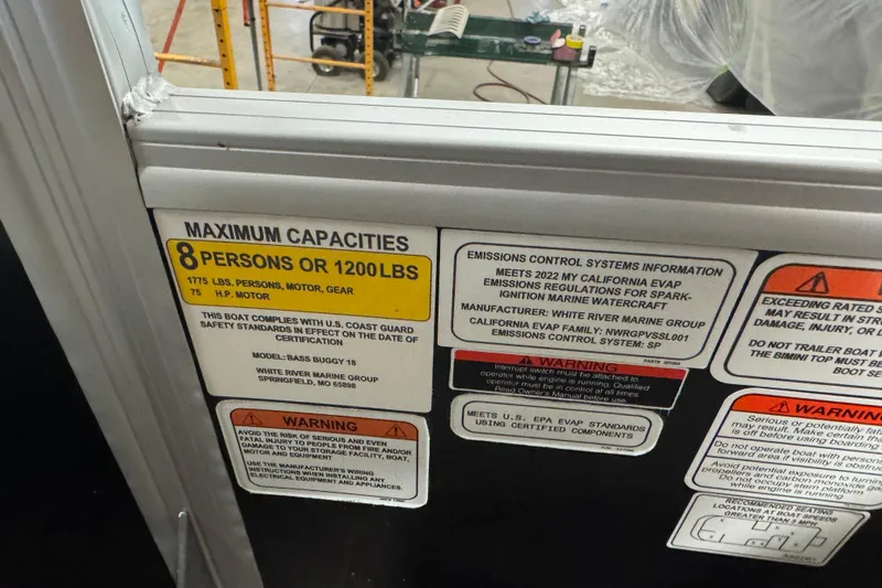 Slide: The Image of 2022 Sun Tracker Bass Buggy 18 DLX capacity and emissions information labels. - 11