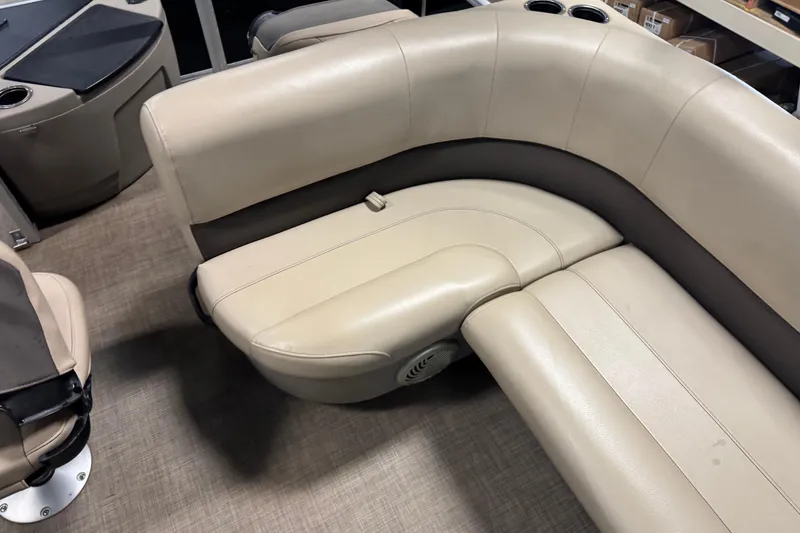 Slide: The Image of 2022 Sun Tracker Bass Buggy 18 DLX boat interior with beige seating and cup holders. - 14