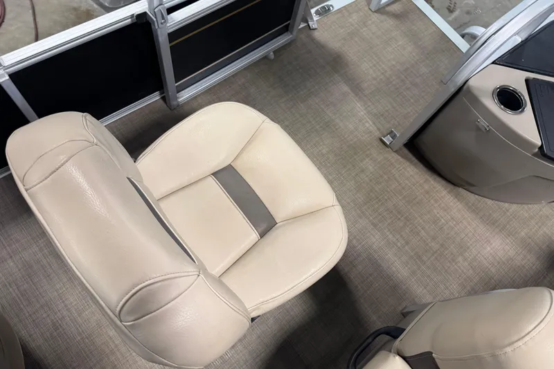 Slide: The Image of 2022 Sun Tracker Bass Buggy 18 DLX interior with beige seating and console. - 15