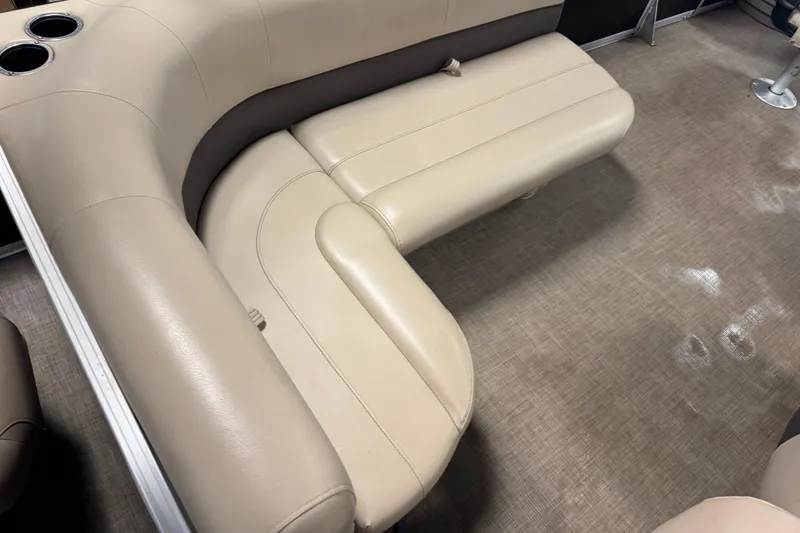 Slide: The Image of 2022 Sun Tracker Bass Buggy 18 DLX beige seating with cup holders on carpeted floor. - 19