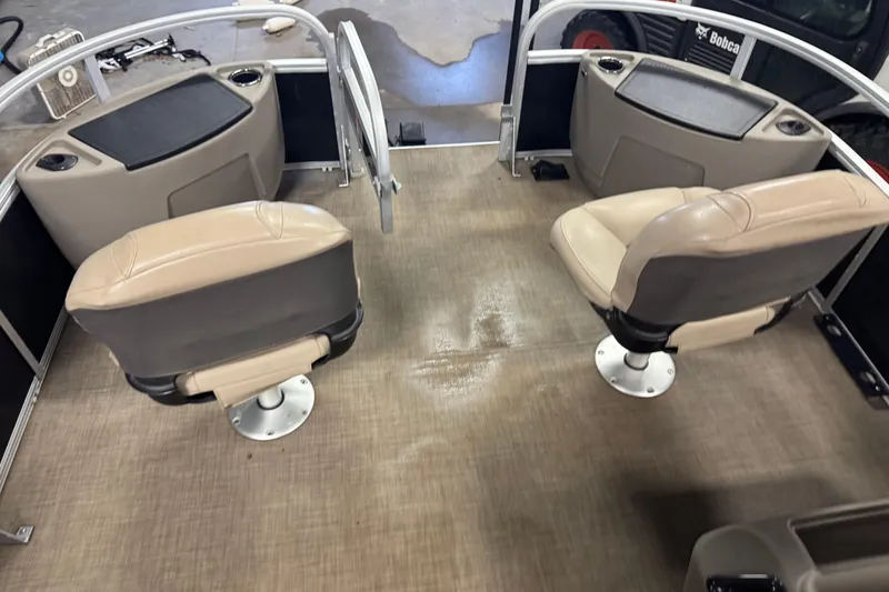 Slide: The Image of 2022 Sun Tracker Bass Buggy 18 DLX interior with two beige seats and storage compartments. - 20