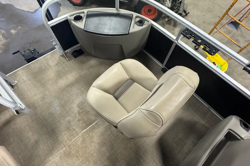 Slide: The Image of 2022 Sun Tracker Bass Buggy 18 DLX interior with beige seating and control panel. - 8