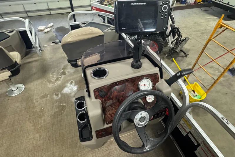 Slide: The Image of 2022 Sun Tracker Bass Buggy 18 DLX boat console with steering wheel and navigation system. - 9