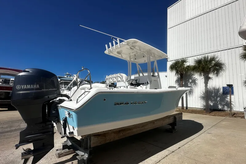Slide: The Image of 2015 Sea Hunt Ultra 211 boat with Yamaha engine, displayed outdoors under clear blue sky. - 3