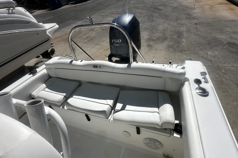 Slide: The Image of 2015 Sea Hunt Ultra 211 boat with cushioned seating and 150 HP outboard motor. - 4