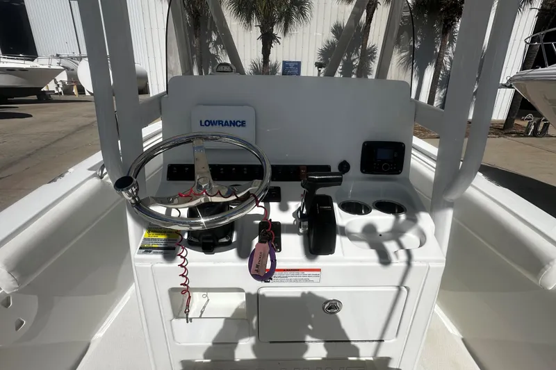 Slide: The Image of 2015 Sea Hunt Ultra 211 boat console with steering wheel and controls. - 5