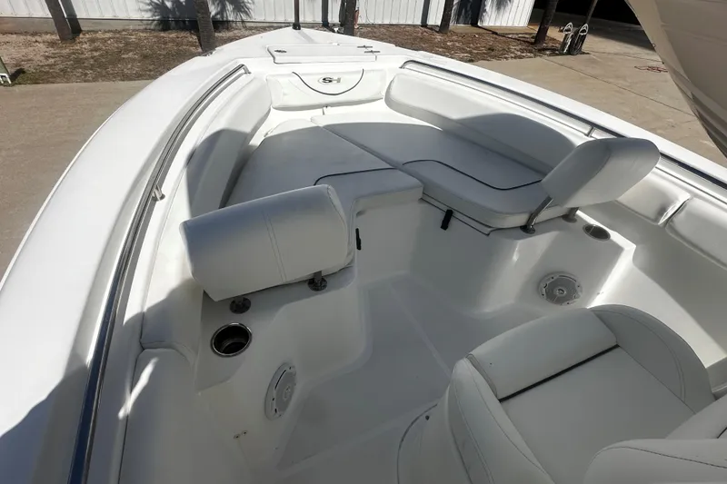 Slide: The Image of 2015 Sea Hunt Ultra 211 boat interior with white seating and cup holders. - 8