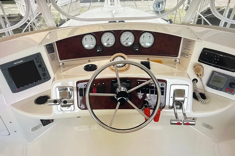 Slide: The Image of 2005 Silverton 34 Convertible helm with steering wheel, gauges, and navigation controls. - 10