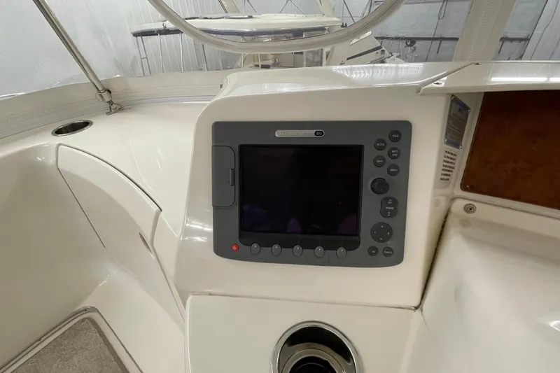 Slide: The Image of 2005 Silverton 34 Convertible boat dashboard with navigation system and controls. - 13