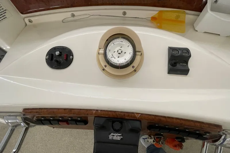 Slide: The Image of Control panel of a 2005 Silverton 34 Convertible boat with compass and switches. - 14