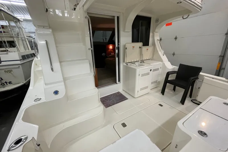 Slide: The Image of 2005 Silverton 34 Convertible yacht interior with stairs, seating, and kitchenette. - 17