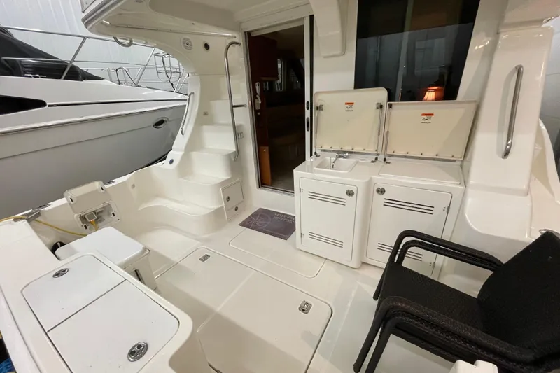 Slide: The Image of 2005 Silverton 34 Convertible yacht interior with seating, storage, and stairs. - 18