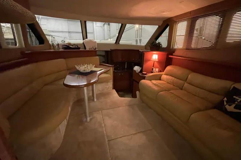 Slide: The Image of Luxurious interior of a 2005 Silverton 34 Convertible yacht with cozy seating and ambient lighting. - 22