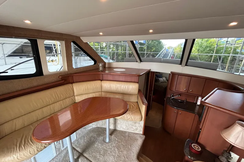 Slide: The Image of Interior of 2005 Silverton 34 Convertible yacht with leather seating and wooden cabinetry. - 23